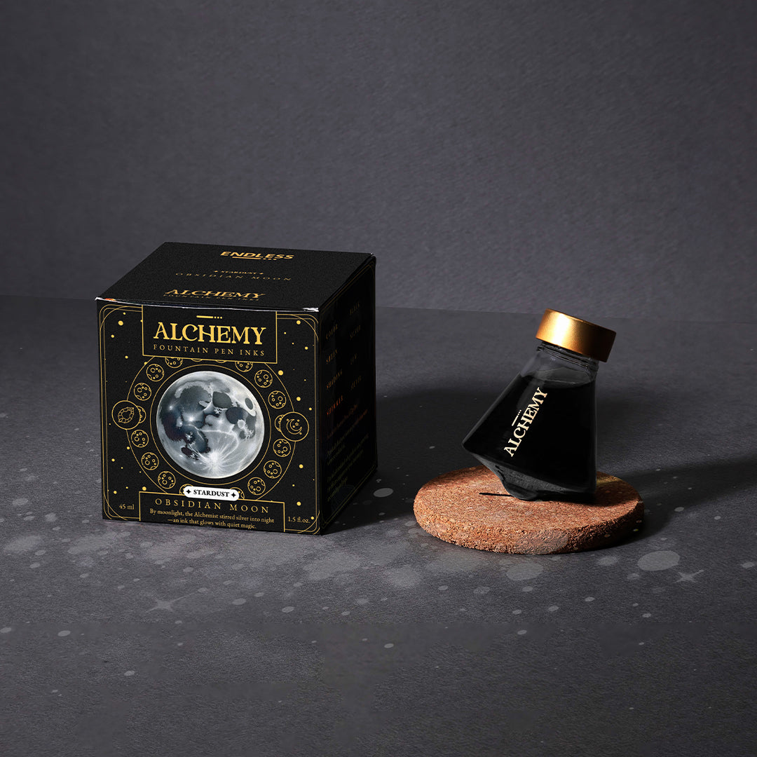 Alchemy fountain pen with packaging on a dark background